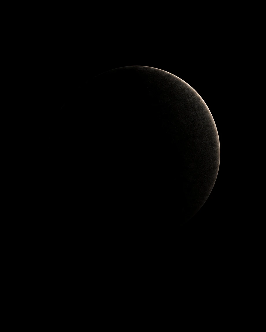 The same sphere in darkness, visible only as a faint rim of light.